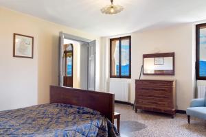 a bedroom with a bed and a dresser and a mirror at Villa Bivai in Bivai +70 photos