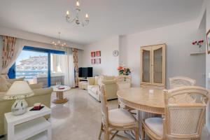 a living room with a table and a dining room at La Terraza del Mar in Manilva