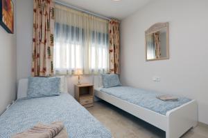 a bedroom with two beds and a window at La Terraza del Mar in Manilva +33 photos