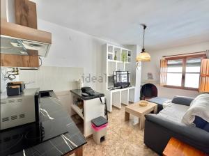 a living room with a couch and a kitchen at Apartamento Rey Melchor in Trevélez +7 photos