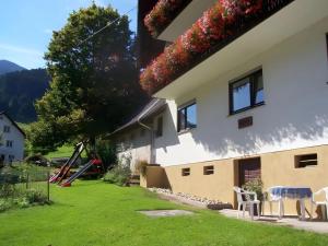 a view of a house with a playground at Kuryhof in Simonswald