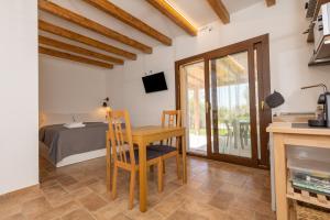 a kitchen and dining room with a table and a bed at Oltremare in Riparbella