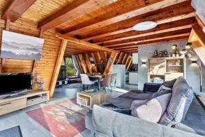 a living room with a couch and a television at Villa Natura in Meschede
