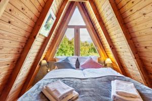 a bed in a room with a large window at Villa Natura in Meschede