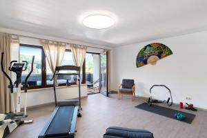 a gym with exercise equipment in a room with a window at Haus Erika Ferienwohnung 2 in Bad Teinach-Zavelstein