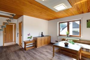 a living room with a wooden ceiling at Haus Erika Ferienwohnung 2 in Bad Teinach-Zavelstein