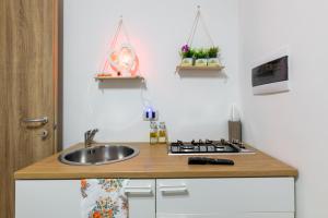 a small kitchen with a sink and a stove at L'aurora in San Vito dei Normanni