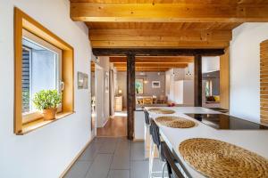 a kitchen with white countertops and wooden ceilings at Ferienwohnung Rabus in Bisingen