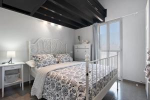 a white bedroom with a bed and a desk and a window at Place Oasis Green Luxury Pool in Maspalomas +18 photos