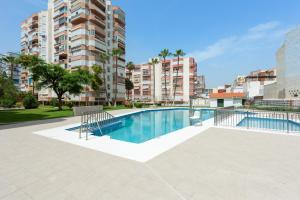 a swimming pool in a apartment with buildings at Apartamento Lucía in Torre del Mar