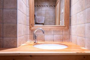 a bathroom with a sink and a mirror at Savine in Val Cenis