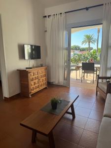 a living room with a couch and a coffee table at Los Porches k29 in Playa del Ingles