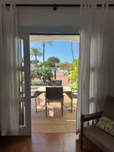 a living room with a door open to a patio at Los Porches k29 in Playa del Ingles