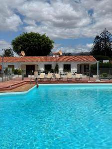 a large swimming pool in front of a building at Los Porches k29 in Playa del Ingles