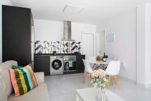a living room with a couch and a kitchen at Noray 2 in La Santa
