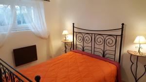a bedroom with a bed and a flat screen tv at Gîte Du Vignal in Mazeyrat-d'Allier