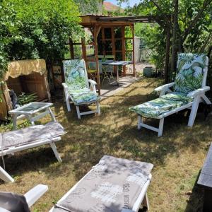 a group of chairs and a table in a yard at Gîte Du Vignal in Mazeyrat-d'Allier