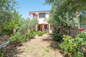 a house with a garden in front of it at Sardegna Budoni giardino e Jacuzzi in Budoni +23 photos