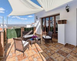 a patio with chairs and tables on a roof at El Paladin in Zufre