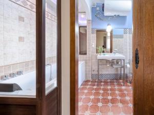 a bathroom with a tub and a sink at El Paladin in Zufre +22 photos
