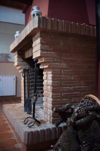 a brick fireplace with a light on top of it at El Paladin in Zufre