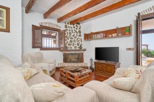 a living room with couches and a tv and a fireplace at Casa Miraflores in Arenas