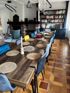 a long wooden table and chairs in a room at La Buissonnière in Erckartswiller
