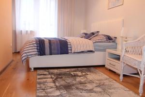 a bedroom with a bed and a window at Apartament Rajska in Gdańsk