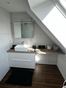 a bathroom with a sink and a mirror at La Buissonnière in Erckartswiller +37 photos