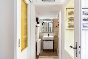 a bathroom with a sink and a mirror at Waldhaus zur Kleinbahn in Glashütte +17 photos