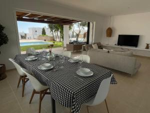 a dining room table with a black and white checkered table cloth at Casa da Lúa in Sant Lluis