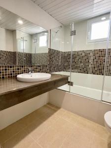 a bathroom with a sink and a shower at Casa da Lúa in Sant Lluis +23 photos