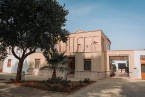 a large white building with a tree in front of it at Ca Margarita in Benegida