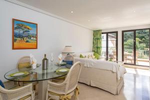 a living room with a table and a couch at Beautiful penthouse with solarium in Benahavís