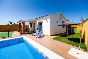 a villa with a swimming pool and a house at Luisa 2 in Conil de la Frontera