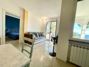 a living room with a couch and a table at Villetta My Sea in Spotorno