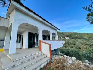a white house with a porch and stairs at Villetta My Sea in Spotorno