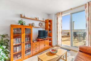 a living room with a tv and a large window at Apartment in Bolnuevo in Bolnuevo