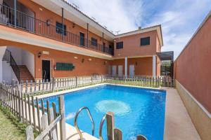 a swimming pool in front of a building at Apartamento Torero ii in Marchena