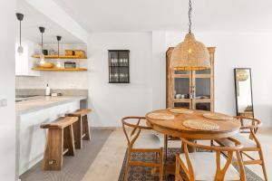 a dining room with a wooden table and chairs at Sea View near La Cala & Marbella in Mijas Costa