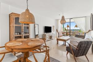 a living room with a wooden table and chairs at Sea View near La Cala & Marbella in Mijas Costa