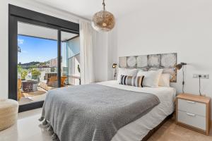 a bedroom with a large bed and a large window at Sea View near La Cala & Marbella in Mijas Costa +14 photos