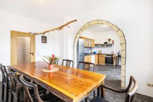 a dining room with a wooden table and chairs at Haus Wipperblick in Osmarsleben +26 photos