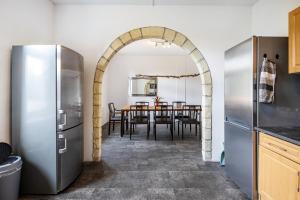 a kitchen with an archway and a table with chairs at Haus Wipperblick in Osmarsleben