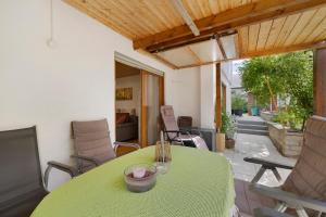 a green table and chairs on a patio at Ferienwohnung Janko in Meßstetten