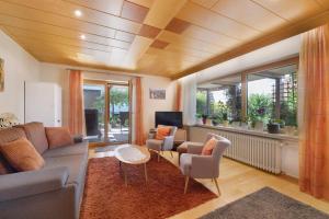 a living room with a couch and chairs and windows at Ferienwohnung Janko in Meßstetten