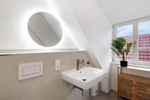 a bathroom with a sink and a mirror at Altes Kutschhaus in Gernsbach +31 photos