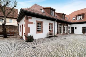 a courtyard of a house with a bench in it at Altes Kutschhaus in Gernsbach