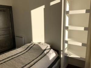 a bedroom with a bed and a book shelf at Famille in La Bourboule +2 photos