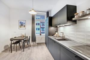 a kitchen with a table and chairs and a dining room at Ferienwohnung Agnes in Dessau